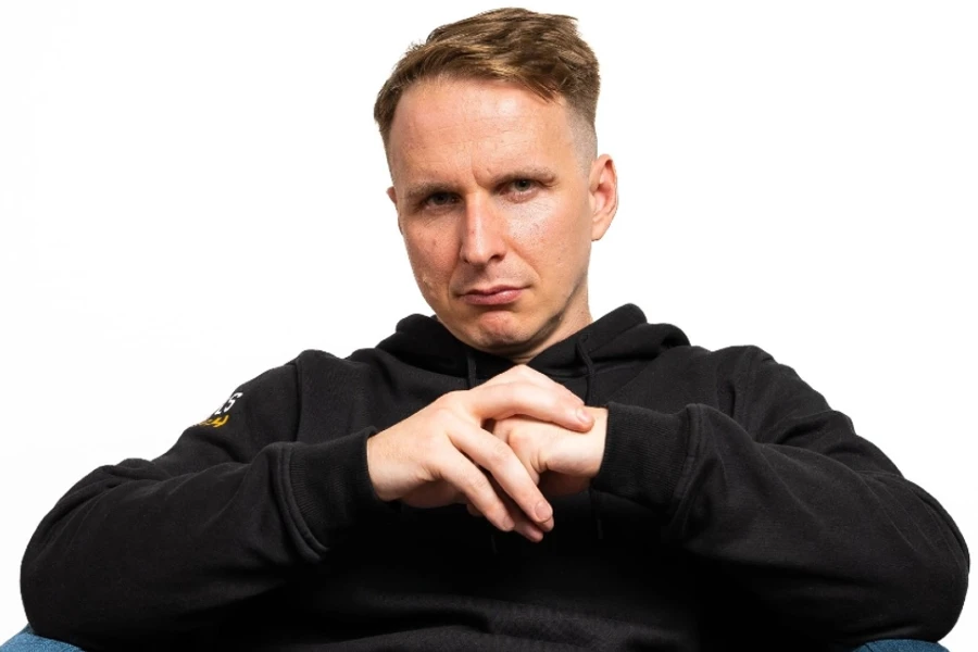 An image showing CoinPoker ambassador Benjamin Rolle, aka Bencb, posing for a photo on a white background.